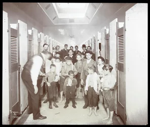 Interior View of Young Men Posed in the Bathing Stall Area at the People